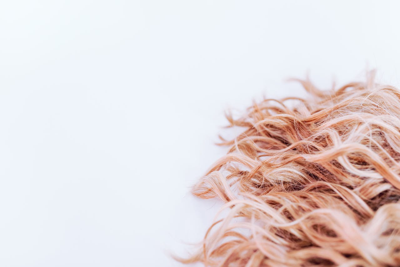 services-01 Detailed close-up of wavy blonde hair texture on a light background, showcasing elegance and style.
